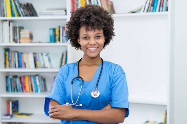 Portrait of laughing african american nurse at work at hospital